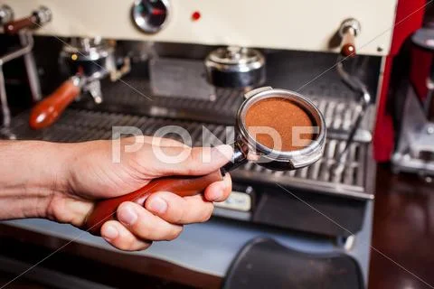 Someone Holdinh Part Of Coffee Machine With Grind Coffe Beans. Close Up
