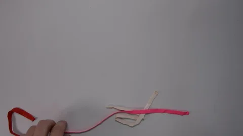 Someone inflating the ballon with hand pump Видео 103032976