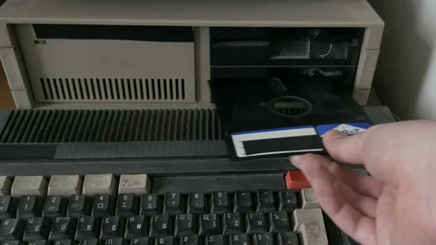 Someone inserting and removing an old-style floppy disk Stock Footage 91313127