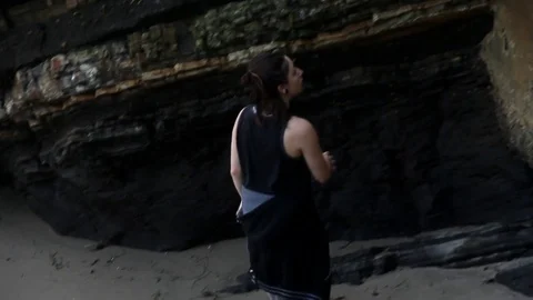 Someone looking around beach caves Stock Footage 83162269