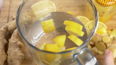Someone makes a handmade drink from lemons, ginger root and pineapple. 4k, slow Stock Footage 83602754