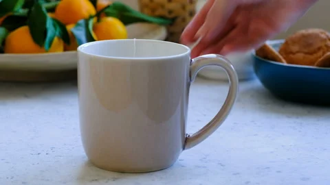 Someone making tea with tea bags in a big cup Stock Footage 96733339