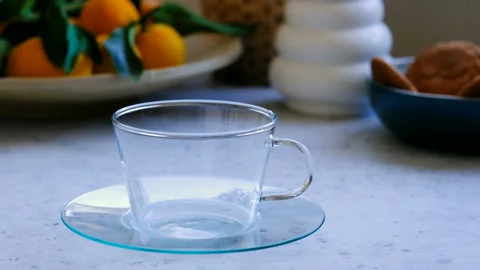 Someone making tea with tea bags in a glass cup Stock Footage 96736145