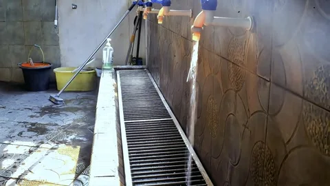 Someone opened the water tap for ablution Stock Footage 289696619