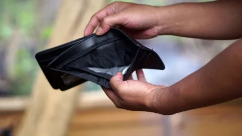 Someone opening an empty black leather wallet containing no cash Stock Footage 345476607