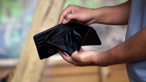 Someone opening an empty black leather wallet containing no cash Stock Footage 345476680