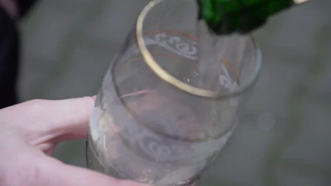 Someone opens the champagne and pours into glass Stock Footage 101818582