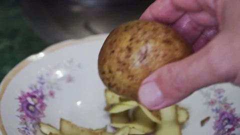 Someone peels potatoes closeup Stock Footage 102174158