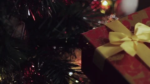 Someone placed a postcard on top of a christmas gift box near christmas tree Stock Footage 70228603