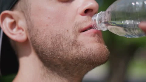Someone Playfully Spits Water While Smiling During Warm Weather Enjoyment Stock Footage 327168065