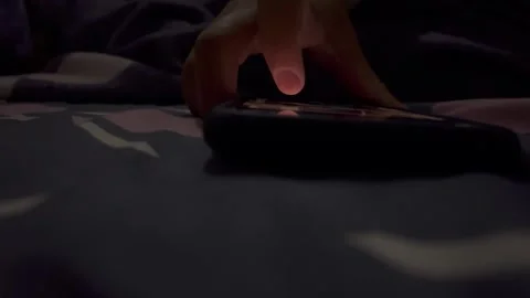 Someone is playing with a smartphone at night Stock Footage 325650512