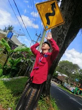 Someone is posing on a traffic sign Stock Photos