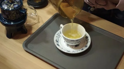 Someone pours tea in a cup Stock Footage 261248973