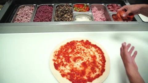 Someone is preparing meat pizza in the kitchen. Stock Footage 131597286