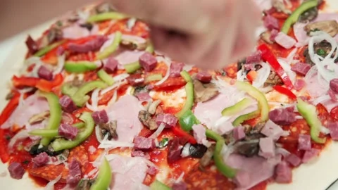 Someone is preparing meat pizza in the kitchen. Stock Footage 131601173