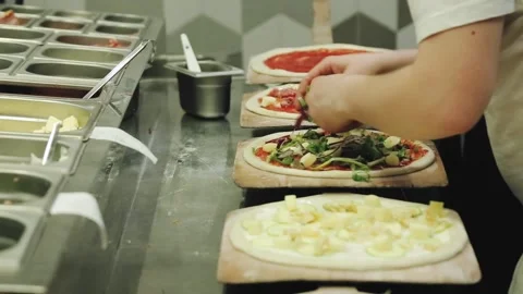 Someone is preparing meat pizza in the kitchen. Stock Footage 134266270