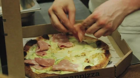 Someone is preparing meat pizza in the kitchen. Stock Footage 134266283