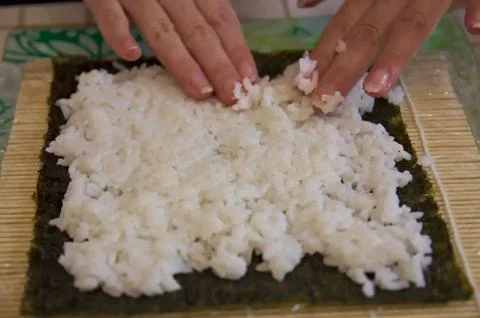 Someone is preparing rice for sushi Stock Photos