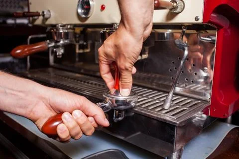 Someone is prepering grind coffe beans to make coffee in coffee machine. Clos Stock Photos