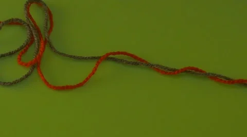 Someone is Pulling Green and Red Yarn on Green Screen Colorful Filament Fiber Stock Footage 61608356