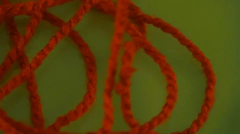 Someone is Pulling Red Thread up Yarn Green Screen Colorful Filament Fiber Clue Video stock 61604365