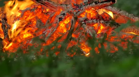 Someone Removes Coals in Fire With a Stick Bonfire People Preparing to Rite of 動画素材 64797301
