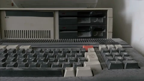 Someone removing an old-style floppy disk from retro computer Stock Footage 91299831