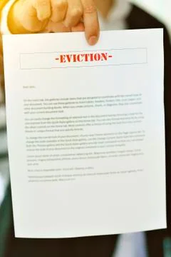Someone serving an Eviction Notice with hands in view - Late Rent - Late Mort Stock Photos