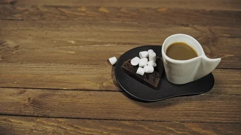 Someone sets the table for Breakfast, coffee and waffles with marshmallows. Stock Footage 100189985