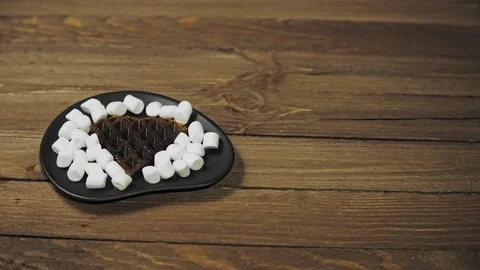 Someone sets the table for Breakfast, coffee and waffles with marshmallows. Stock Footage 101838743