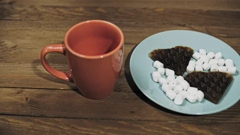 Someone sets the table for Breakfast, coffee and waffles with marshmallows. Stock Footage 101839136