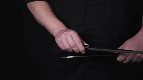 Someone sharpening knives in slow motion. Stock Footage 140484154