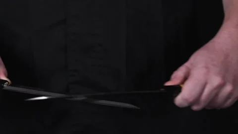 Someone sharpening knives in slow motion. Stock Footage 140484157