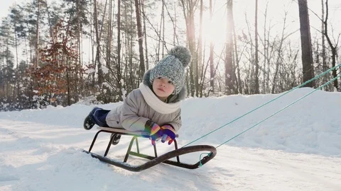 Someone sledding a little boy Stock Footage 101385592
