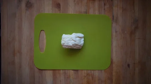 Someone slices cabbage with a knife on a cutting board, top view. Stock Footage 104760382