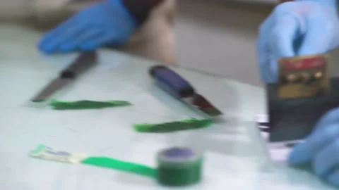 Someone spreading green color for sample test at paint factory Stock Footage 234142720