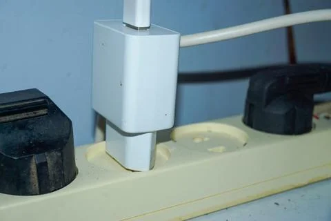 Someone stuck the plug in the socket. someone plugged the phone charger int.. Stock Photos