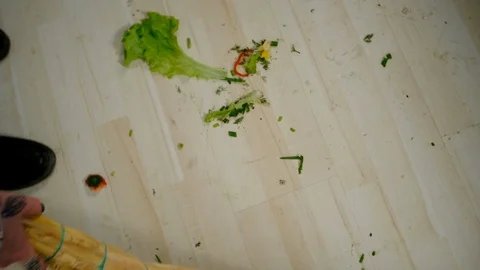 Someone sweeping the floor in the kitchen Stockbeeldmateriaal 127286209