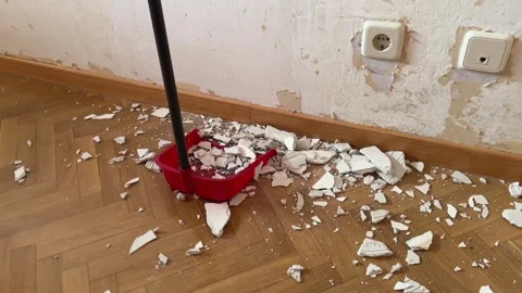 Someone sweeping up plaster debris after renovation Stock Footage 341362903