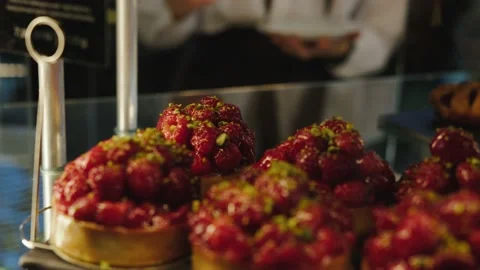 Someone takes a cake from the window and packs it. Stock Footage 223912660