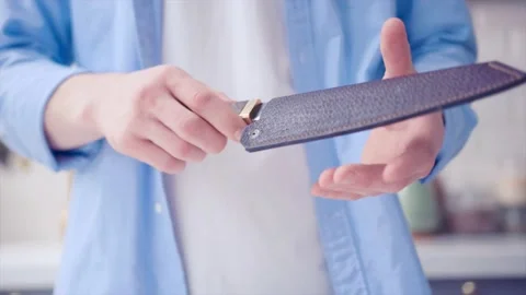 Someone taking the leather case and pulls out the knife. Stock Footage 130991281