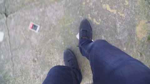 Someone is talking on a cell phone, angry and smashing on the floor and kicking  Stock Footage 104779014