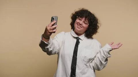 Someone talks to the camera with expressions of joy in a studio with yellow.. Video stock 331990592