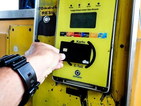 Someone is tapping an e-toll card at a toll gate Stock Photos