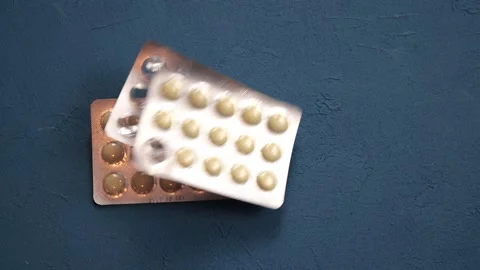 Someone throws medicine tablets on the table, isolated background Stock Footage 141524803