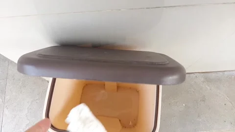 Someone throws a tissue into the trash bin with foot pedal Stock Footage 284442492