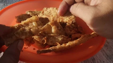 Someone took fried tempeh in a plastic plate, traditional Indonesian food, 4k Video stock 251796273
