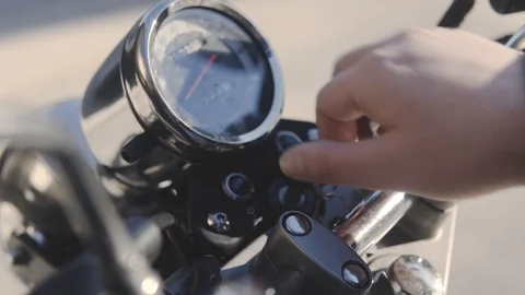 Someone turns the key to turn on a motorcycle. Stock Footage 103172736