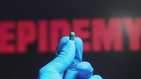 Someone Unknown In Protective Gloves Hands The Pill To The Animated Word Epidemy Stock Footage 135340389