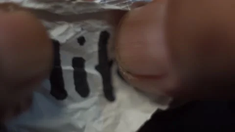 Someone is unrolling a small piece of paper that says: life is Stock Footage 205584914